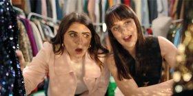 Two friends shopping for clothes